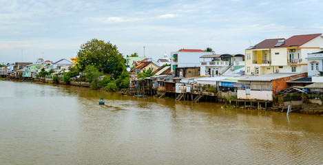 Fototapeta na wymiar Riverside stilt houses in the Mekong Delta