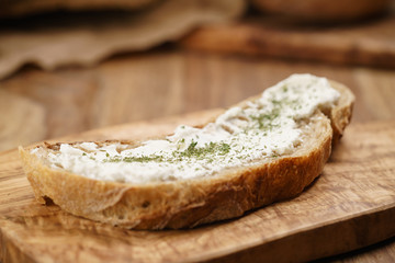 ricotta cheese with herbs on fresh rustic bread