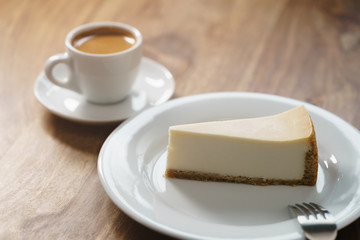 fresh espresso and cheesecake on table