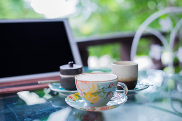 Beautiful cup of hot drink with coffee in coffee shop.