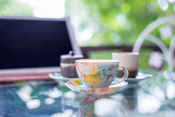 Cup of hot drink with coffee on table.