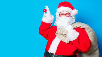 Fototapeta na wymiar Funny Santa Claus have a fun with light bulb