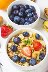 crunchy flakes with blueberries and various yogurts for healthy breakfast, close-up