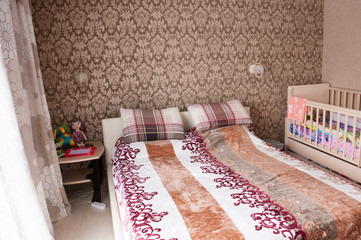 Modern interior, bedroom in brown tones, large bed