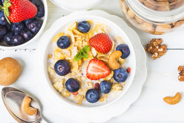 crunchy flakes with blueberries and various yogurts for healthy breakfast, close-up