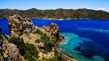 Blue sea, mountains and trees.