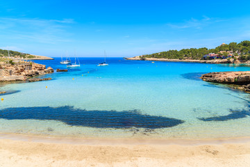 Idyllic Cala Portinatx beach with shallow crystal clear sea water, Ibiza island, Spain