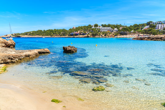 Idyllic Cala Portinatx beach with shallow crystal clear sea water, Ibiza island, Spain