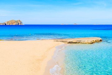 Beautiful sandy Cala Comte beach with azure blue sea water, Ibiza island, Spain © pkazmierczak