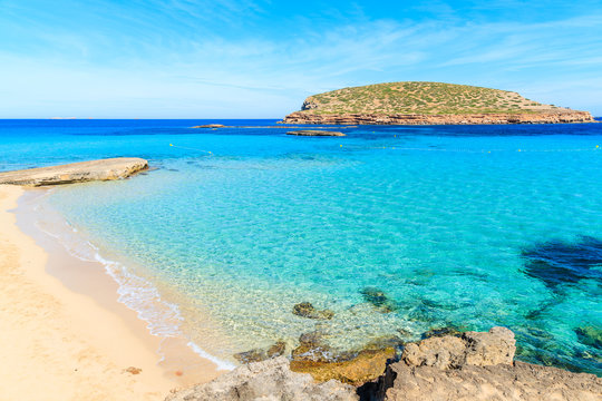 Beautiful sandy Cala Comte beach with azure blue sea water, Ibiza island, Spain
