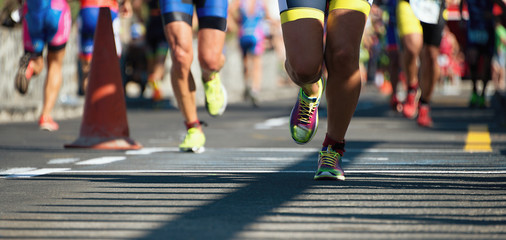Naklejka premium Marathon running race, people feet on city road
