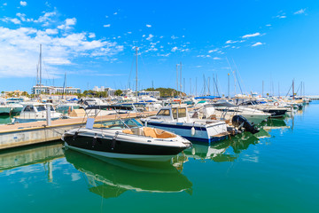 Fototapeta premium Luxury motor and sailing boats anchoring in Santa Eularia modern marina, Ibiza island, Spain