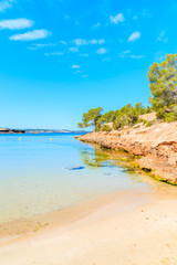 Obraz premium View of beautiful Cala Gracioneta beach and bay at early morning, Ibiza island, Spain