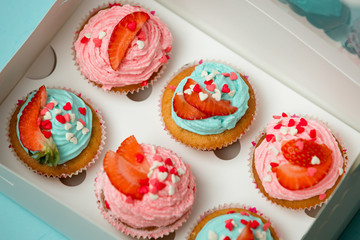 Closeup photo of decorated cupcakes in box