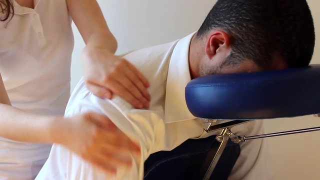 businessman receiving shiatsu on a quick massage chair