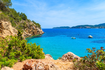 Rocks and azure blue sea of Cala San Vicente bay, Ibiza island, Spain