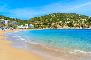 Fototapeta na wymiar View of Cala San Vicente beach with hotels in distance, Ibiza island, Spain