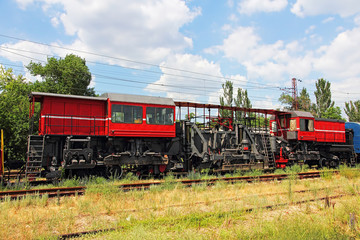 Fototapeta na wymiar Railway track service car fixing and repairing the railroad in rural area at summer.