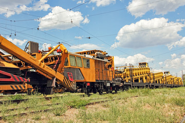 Railway track service car.Crushed stone install construction machine.
