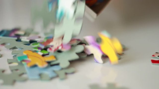 Pouring puzzle pieces from a box