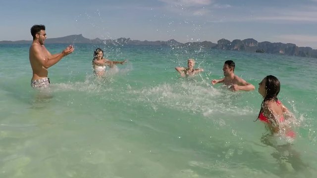 Happy People Group Faving Fun In Water Swimming In Sea On Beach POV, Cheerful Friends Splashing Tourists, Young Men And Women Holiday On Summer Sea Vacation