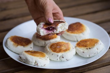 sweet cheese pancakes with cherries  filling  on a plate