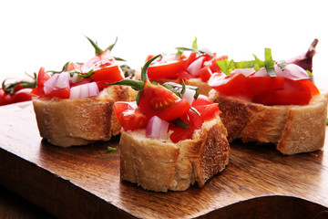 Bruschetta with tomatoes, herbs and oil on toasted garlic cheese bread toasted with chopped tomatoe