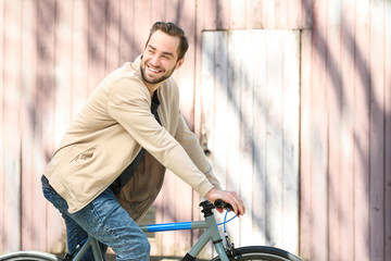 Obraz premium Handsome young man riding bicycle outdoors on sunny day