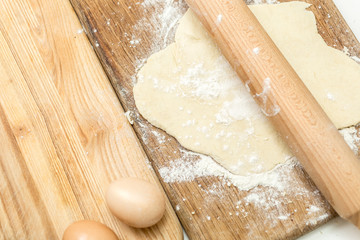 Closeup of dough lying on wooden cooking board