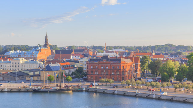 Ystad, Baltic coast, south Sweden. View of waterfront and city in rays of rising sun