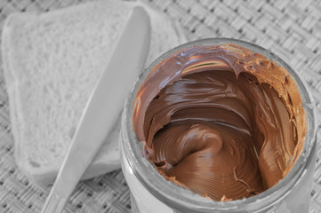Chocolate cream. Bread and knife in black and white background