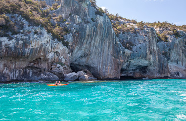 Fototapeta na wymiar Couple kayaking in the Gulf di Orosei, Sardinia, Italy
