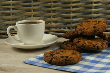 Coffee cup with oatmeal cookie chocolate on wooden background