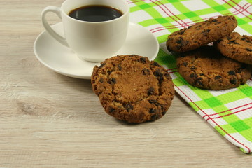 Coffee cup with oatmeal cookie chocolate on wooden background