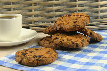 Coffee cup with oatmeal cookie chocolate on wooden background