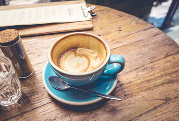 Cup of coffee with latte top view on wooden table/vintage .