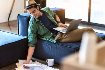 Happy young man working with papers