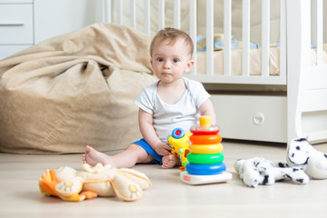 10 months old baby boy playing with colorful toy tower