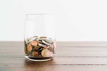 Coins and plant in glass, business investment growth and saving concept.