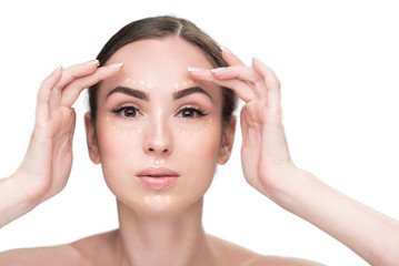 Fototapeta premium Concentrated lady using beige foundation