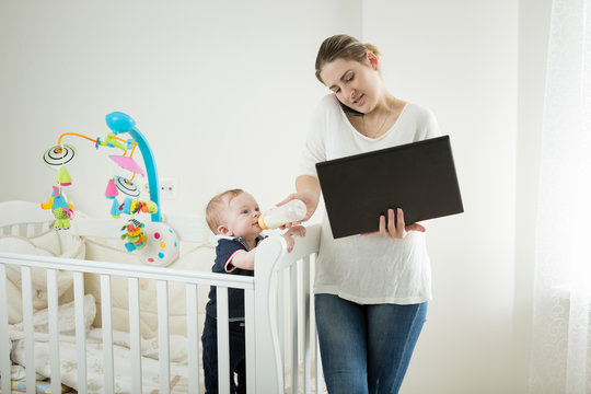 Young Businesswoman Working From Home With Her 9 Months Old Baby