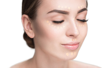 Obraz premium Beautiful young lady has concealer on face