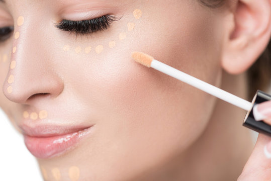 Happy smiling attractive girl doing make-up