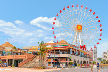 American Village with a huge ferris wheel under the clear sky on June 2, 2013 in Okinawa, Japan.
