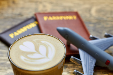 Latte glass close up. Coffee and toy plane.