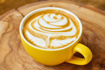 Latte cup close up. Rose coffee foam art.