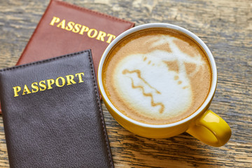 Passports and coffee cup. Latte art palm trees. Make international travel easier.