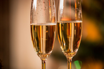 Macro image of champagne bubbles in two glasses