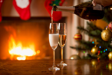 Two glasses of champagne being filled from bottle