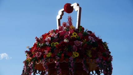 gorgeous baskets full of flowers in wind.clouds in blue sky. - Powered by Adobe